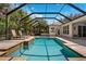 Gorgeous screened-in pool with lounge chairs and outdoor seating area, perfect for relaxation and entertaining at 15930 Sorawater Dr, Lithia, FL 33547