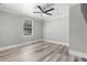 This bedroom offers a ceiling fan, modern flooring and a window at 1600 E Hanna Ave, Tampa, FL 33610