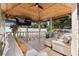 Cozy gazebo with plush seating, ceiling fan, and mounted television perfect for outdoor entertaining on paver patio at 1600 E Hanna Ave, Tampa, FL 33610