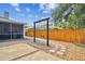 Backyard with a swing set, stone walkway, decorative rocks, wooden fence, and screened porch at 16608 Meadow Cove St, Tampa, FL 33624