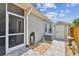 Exterior view of backyard area with patio, shed, air conditioner, and beautiful landscape at 16608 Meadow Cove St, Tampa, FL 33624