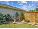Well-manicured backyard with a charming statue garden, decorative stones and lovely shrubbery at 16608 Meadow Cove St, Tampa, FL 33624