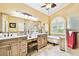 Well-appointed bathroom featuring double vanities, a soaking tub, and natural light at 16608 Meadow Cove St, Tampa, FL 33624
