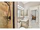 Bathroom with a walk-in shower, granite countertops, modern lighting, and neutral tones at 16608 Meadow Cove St, Tampa, FL 33624