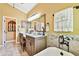 Charming bathroom with double vanities, a soaking tub, and stylish fixtures at 16608 Meadow Cove St, Tampa, FL 33624