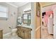 Bathroom features a granite countertop vanity, decorative towels, and access to the next room at 16608 Meadow Cove St, Tampa, FL 33624