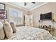 Cozy bedroom featuring a neutral palette, window shutters, and a glass side table at 16608 Meadow Cove St, Tampa, FL 33624