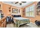 Comfortable bedroom with unique animal-themed decor, natural light, and ceiling fan at 16608 Meadow Cove St, Tampa, FL 33624