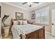 Bedroom boasts a floral-patterned bedspread, bamboo details, and ample natural light at 16608 Meadow Cove St, Tampa, FL 33624