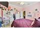 Pink bedroom with a purple comforter, white furniture, and a desk at 16608 Meadow Cove St, Tampa, FL 33624