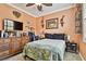 Cozy bedroom features a zebra-print comforter, mounted TV, and an array of animal decor at 16608 Meadow Cove St, Tampa, FL 33624