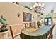 Formal dining area showcasing a chandelier, decorative wall accents, and a table ready for entertaining at 16608 Meadow Cove St, Tampa, FL 33624
