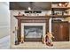 Close-up of a fireplace with a decorative mantel and hearth, flanked by built-in cabinets and shelves at 16608 Meadow Cove St, Tampa, FL 33624