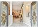 Elegant foyer featuring tile flooring, decorative columns, and an inviting view into the dining area at 16608 Meadow Cove St, Tampa, FL 33624