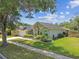 Attractive single-story house features a well-manicured lawn, lush landscaping, and convenient two-car garage at 16608 Meadow Cove St, Tampa, FL 33624