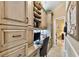 Well-lit home office features custom cabinetry with storage, built-in desk, and neutral color palette at 16608 Meadow Cove St, Tampa, FL 33624