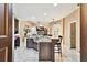 Spacious kitchen featuring a large island with seating, granite countertops, and modern cabinetry at 16608 Meadow Cove St, Tampa, FL 33624