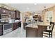 Well-appointed kitchen with granite countertops, stainless steel appliances, and dark wood cabinetry at 16608 Meadow Cove St, Tampa, FL 33624