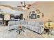 Open-concept living room with tile floors, comfortable seating, and a view into the adjacent kitchen at 16608 Meadow Cove St, Tampa, FL 33624