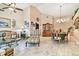 Open-concept living room with tile floors, a large china cabinet, and comfortable seating at 16608 Meadow Cove St, Tampa, FL 33624