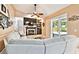 Cozy living room with a fireplace, large television, comfortable seating, and access to an outdoor patio at 16608 Meadow Cove St, Tampa, FL 33624
