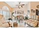 Elegant living room featuring travertine floors, vaulted ceiling, and refined furniture at 16608 Meadow Cove St, Tampa, FL 33624