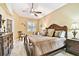 Serene bedroom with a ceiling fan, neutral color palette, and decorative furniture at 16608 Meadow Cove St, Tampa, FL 33624