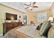 Comfortable bedroom features a ceiling fan, decorative furniture, and a cozy atmosphere at 16608 Meadow Cove St, Tampa, FL 33624