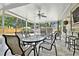 Screened patio with large table, bar seating, and view of the landscaped backyard at 16608 Meadow Cove St, Tampa, FL 33624