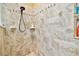 Tiled shower with a built-in niche and modern fixtures at 16608 Meadow Cove St, Tampa, FL 33624