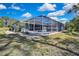Home's enclosed pool and patio area with lush landscaping, ideal for outdoor living at 17364 Mediterranean Cir, Weeki Wachee, FL 34614