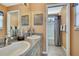Bathroom with a double vanity featuring granite countertops, neutral walls and tiled flooring at 17364 Mediterranean Cir, Weeki Wachee, FL 34614