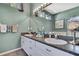 Bathroom with a double sink vanity and decorative mirror at 17364 Mediterranean Cir, Weeki Wachee, FL 34614
