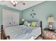 Bright bedroom showcases a bed with decorative pillows, a ceiling fan, and closet space at 17364 Mediterranean Cir, Weeki Wachee, FL 34614