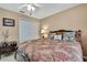 Bedroom with decorative bedding, ceiling fan, and white double door closet at 17364 Mediterranean Cir, Weeki Wachee, FL 34614
