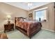 Cozy bedroom with a ceiling fan and a large bed with decorative pillows at 17364 Mediterranean Cir, Weeki Wachee, FL 34614