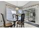 Dining area with natural light, tiled floor, and glass door leading to outdoor patio at 17364 Mediterranean Cir, Weeki Wachee, FL 34614