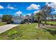 Charming home with lush landscaping, a well-manicured lawn, and a spacious driveway at 17364 Mediterranean Cir, Weeki Wachee, FL 34614