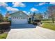 Charming home with lush landscaping, a well-manicured lawn, and a spacious three-car garage at 17364 Mediterranean Cir, Weeki Wachee, FL 34614