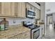 Close up of a kitchen featuring stainless steel appliances and granite countertops at 17364 Mediterranean Cir, Weeki Wachee, FL 34614