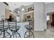Bright kitchen with eat-in bar, stainless appliances, and tile floors at 17364 Mediterranean Cir, Weeki Wachee, FL 34614