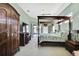Spacious primary bedroom with canopy bed, ceiling fan, and furniture at 17364 Mediterranean Cir, Weeki Wachee, FL 34614