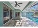 Covered patio overlooking a stunning pool, ideal for relaxation and entertaining at 17364 Mediterranean Cir, Weeki Wachee, FL 34614