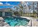 Enclosed pool features a beautiful deck, turquoise water, and view of the surrounding landscape at 17364 Mediterranean Cir, Weeki Wachee, FL 34614