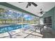 Enclosed pool area offering views of the backyard oasis with a seating area for relaxation and entertainment at 17364 Mediterranean Cir, Weeki Wachee, FL 34614