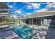Enclosed pool features a beautiful deck, turquoise water, and access to the home at 17364 Mediterranean Cir, Weeki Wachee, FL 34614