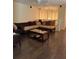 Inviting living room with comfortable seating, wood floors, and a modern ceiling fan at 1746 Heron Cove Dr # 1746, Lutz, FL 33549