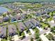 Overhead shot of a suburban neighborhood featuring green spaces, water features, and beautifully maintained properties at 17740 Bright Wheat Dr, Lithia, FL 33547