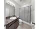 Bathroom featuring a vanity with granite countertop and a shower with a striped curtain at 17740 Bright Wheat Dr, Lithia, FL 33547