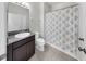 Neutral bathroom with a granite vanity and a shower with a floral curtain at 17740 Bright Wheat Dr, Lithia, FL 33547